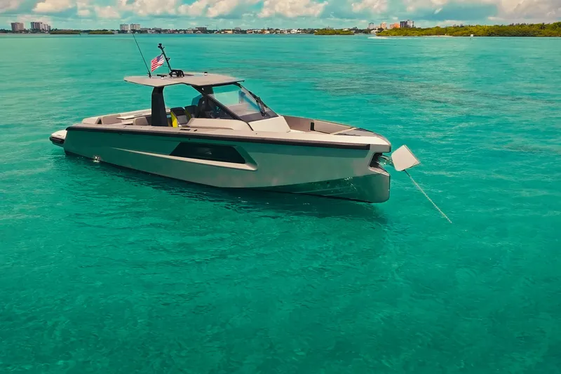 Slide: The Image of 2024 Maori 46ft yacht anchored in clear turquoise waters under a sunny sky. - 12