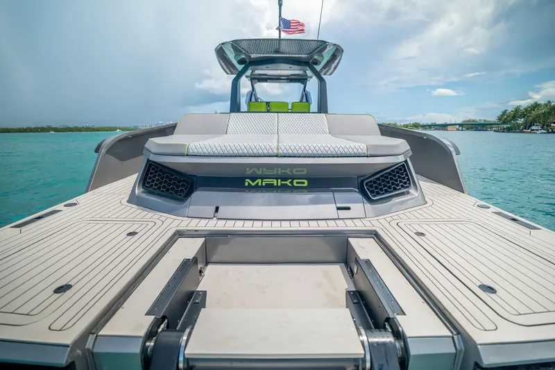 Slide: The Image of 2024 Maori 46ft yacht with sleek design on turquoise water, featuring modern deck and seating. - 28