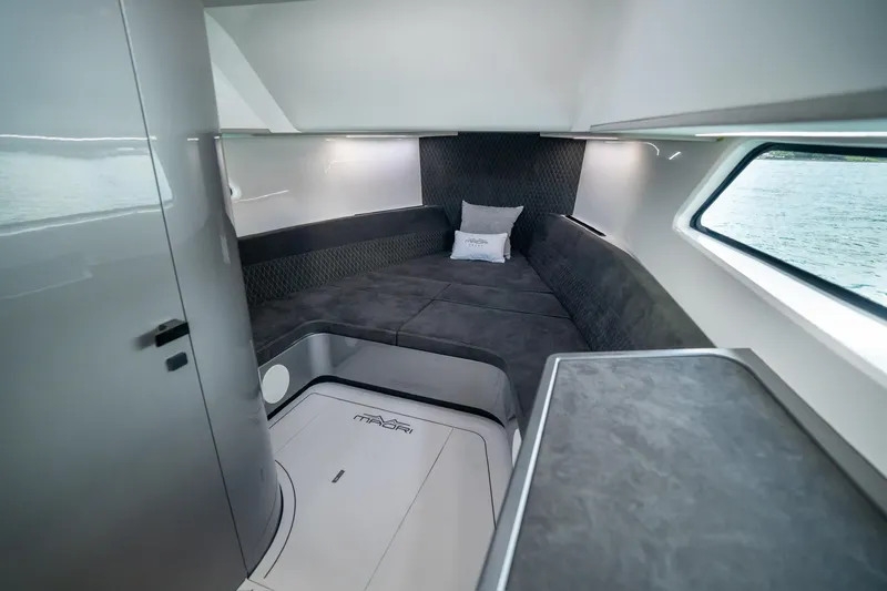 Slide: The Image of Luxurious interior of 2024 Maori 46ft yacht with modern seating and window view. - 32