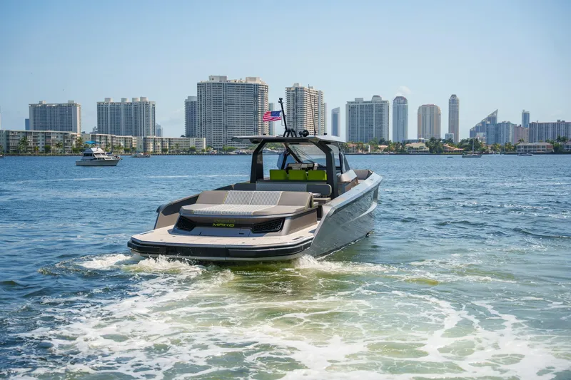 Slide: The Image of 2024 Maori 46ft yacht cruising near city skyline, clear blue water, and sunny skies. - 37