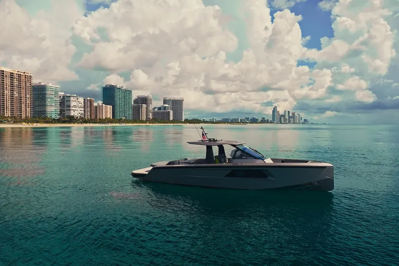 Slide: The Image of 2024 Maori 46ft yacht cruising near city skyline under cloudy sky. - 4