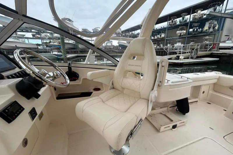 Slide: The Image of 2022 Grady-White Freedom 235 boat interior with helm and luxurious seating. - 12