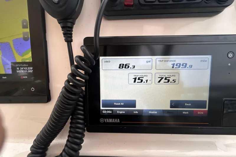 Slide: The Image of Dashboard of a 2022 Grady-White Freedom 235 boat showing trip data and GPS coordinates. - 14