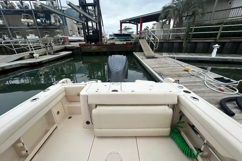 Slide: The Image of 2022 Grady-White Freedom 235 boat docked at marina with outboard motor. - 4
