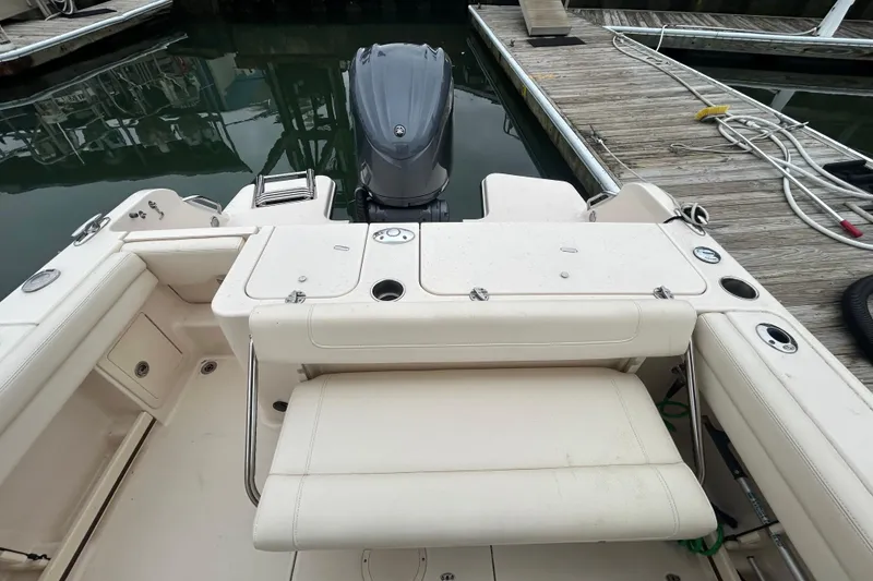 Slide: The Image of 2022 Grady-White Freedom 235 boat interior with seating and motor at dock. - 5