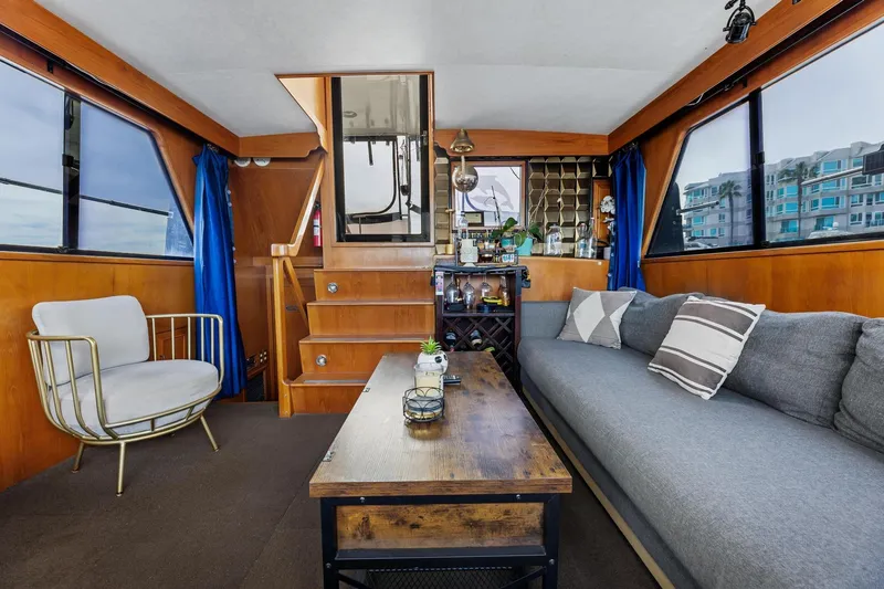 Slide: The Image of Interior of 1988 Marine Trader Trawler with cozy seating, wooden accents, and nautical decor. - 12