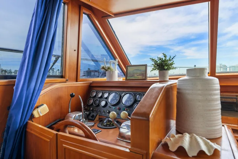 Slide: The Image of 1988 Marine Trader Trawler helm with nautical decor and panoramic windows. - 15
