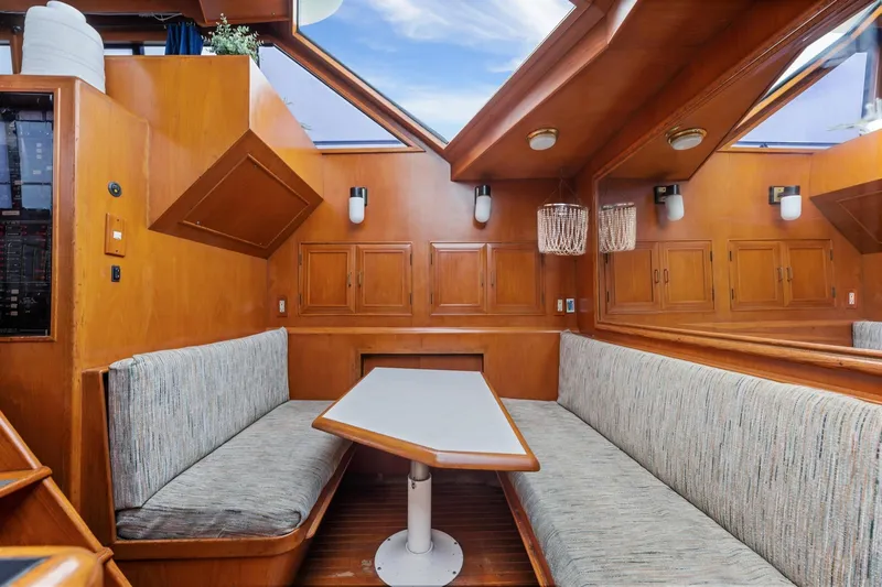 Slide: The Image of 1988 Marine Trader Trawler interior with wood paneling and cozy seating area. - 21