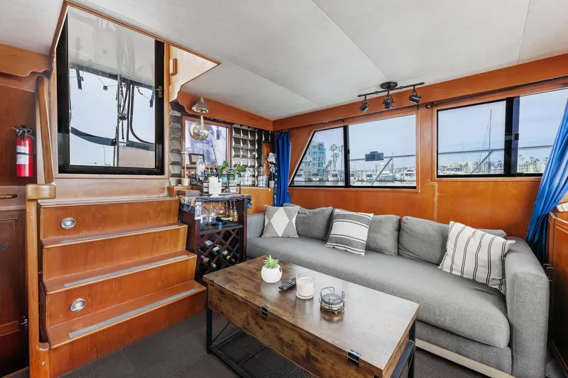 Slide: The Image of Interior of 1988 Marine Trader Trawler with cozy seating, wooden accents, and nautical decor. - 22