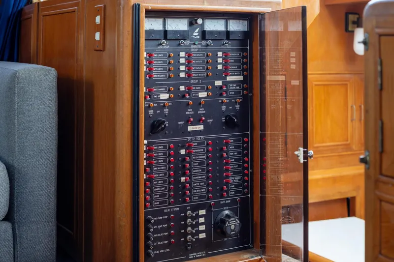 Slide: The Image of Electrical panel inside a 1988 Marine Trader Trawler, showcasing switches and controls. - 23