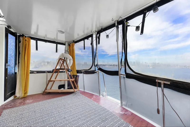 Slide: The Image of 1988 Marine Trader Trawler interior with panoramic windows and nautical decor. - 25