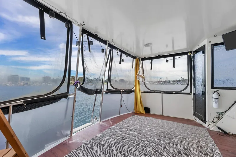 Slide: The Image of 1988 Marine Trader Trawler interior with panoramic windows and nautical decor. - 26
