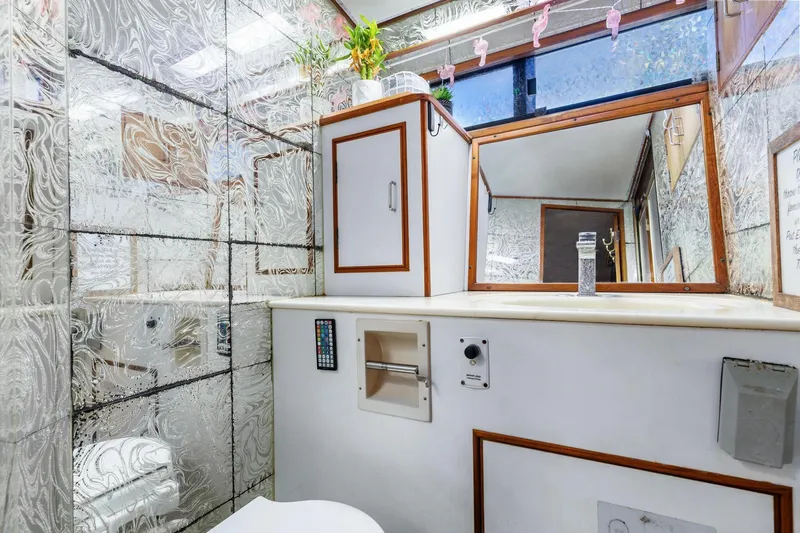 Slide: The Image of 1988 Marine Trader Trawler bathroom with decorative glass walls and modern fixtures. - 35