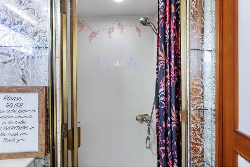 Slide: The Image of Shower area in 1988 Marine Trader Trawler with decorative curtain and wall sign. - 36