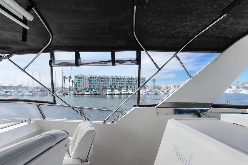 Slide: The Image of 1988 Marine Trader Trawler interior view overlooking marina and waterfront buildings. - 48