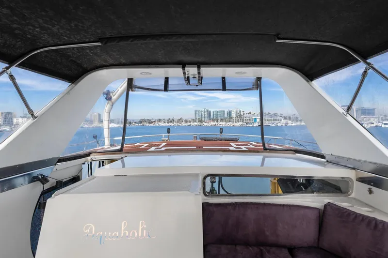 Slide: The Image of 1988 Marine Trader Trawler interior with marina view, featuring comfortable seating and modern design. - 53