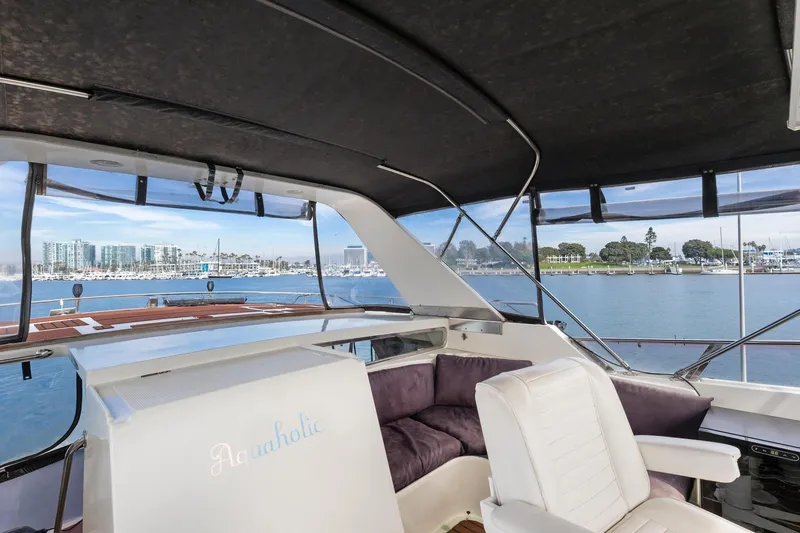 Slide: The Image of 1988 Marine Trader Trawler interior with seating, overlooking marina and waterfront views. - 55