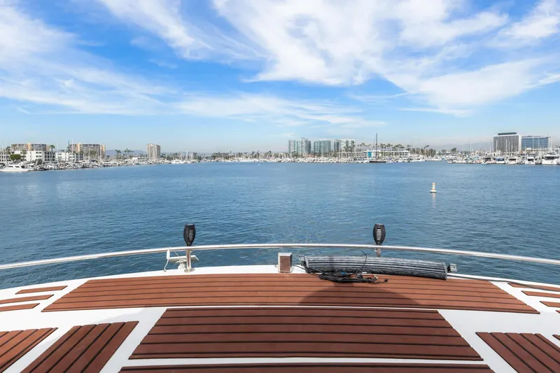 Slide: The Image of 1988 Marine Trader Trawler deck overlooking marina with clear blue sky and cityscape. - 58