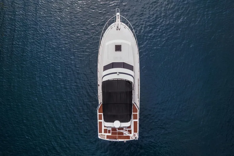 Slide: The Image of Overhead view of a 1988 Marine Trader Trawler on calm blue water. - 7