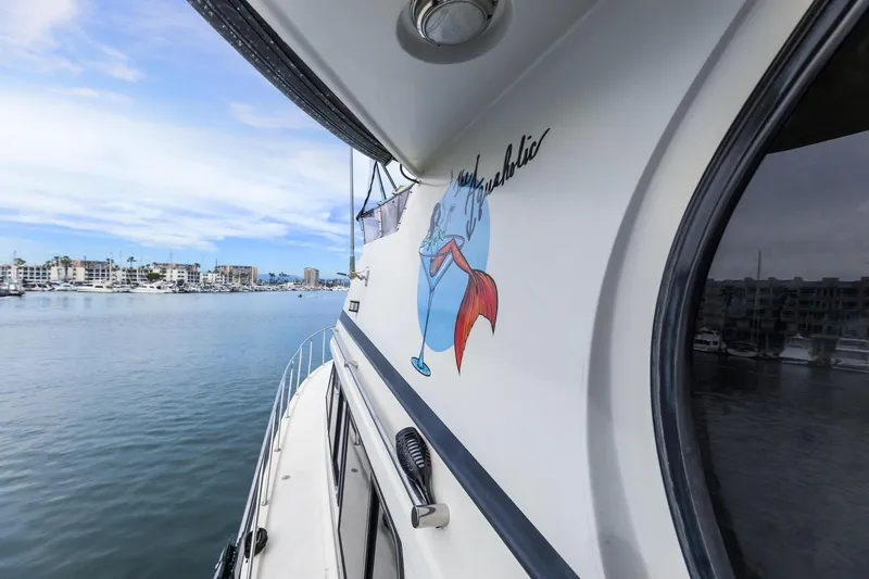 Slide: The Image of 1988 Marine Trader Trawler on calm water, featuring a colorful mermaid graphic. - 8