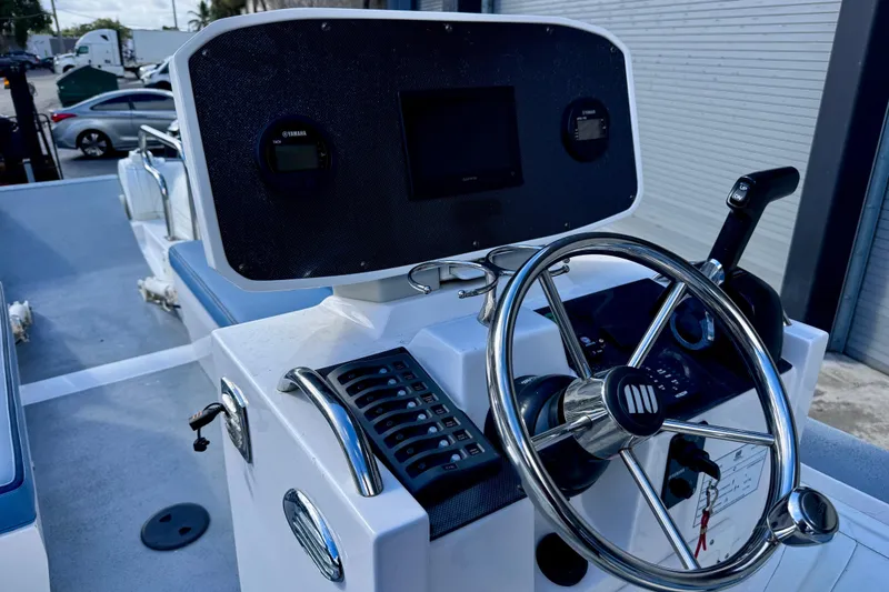 Slide: The Image of 2023 Novurania Catamaran 20 dashboard with steering wheel and control panel. - 12
