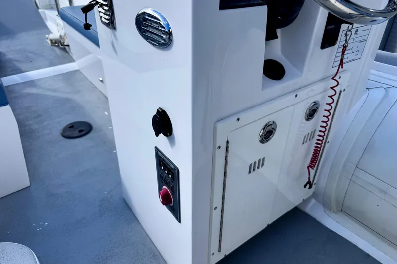 Slide: The Image of 2023 Novurania Catamaran 20 interior console with controls and seating. - 13