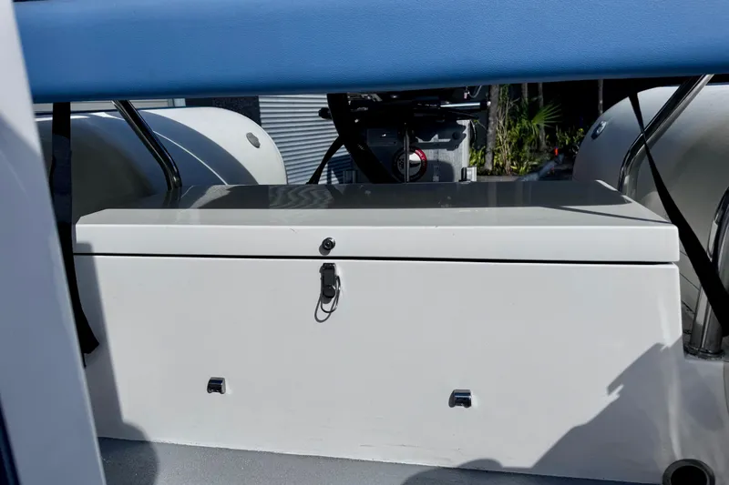 Slide: The Image of 2023 Novurania Catamaran 20 interior with storage compartment and blue seating. - 17