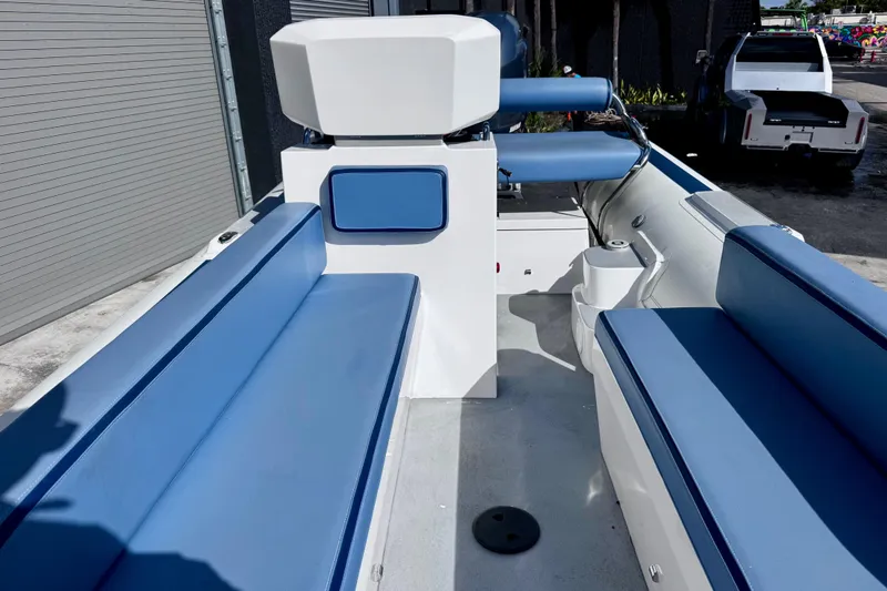 Slide: The Image of 2023 Novurania Catamaran 20 with blue seating, docked outdoors. - 7