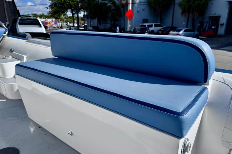 Slide: The Image of Blue cushioned seating on 2023 Novurania Catamaran 20, parked outdoors. - 8