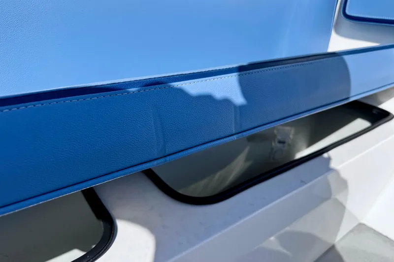 Slide: The Image of 2023 Novurania Catamaran 20 interior detail with blue upholstery and storage compartment. - 9