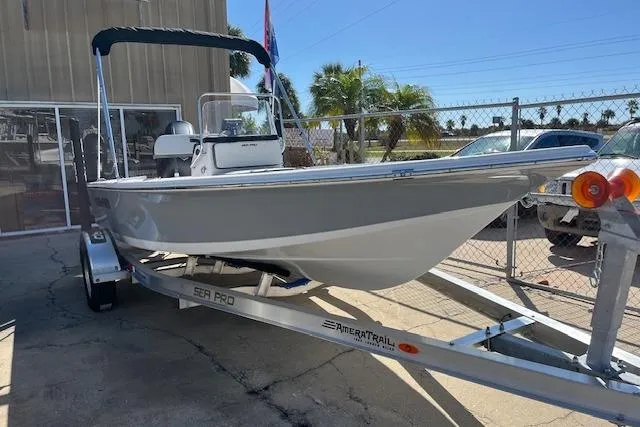 Slide: The Image of 2026 Sea Pro 172 Bay boat on trailer, parked outdoors under clear sky. - 12