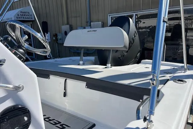 Slide: The Image of 2026 Sea Pro 172 Bay boat interior with steering wheel and seating, parked near service entrance. - 3