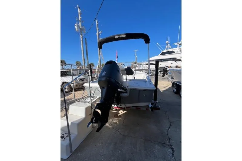 Slide: The Image of 2026 Sea Pro 172 Bay boat with outboard motor, docked under clear blue sky. - 7