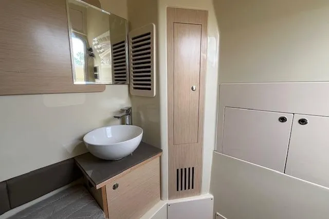 Slide: The Image of 2026 Chris-Craft Catalina 31 interior with modern sink and wooden cabinetry. - 14