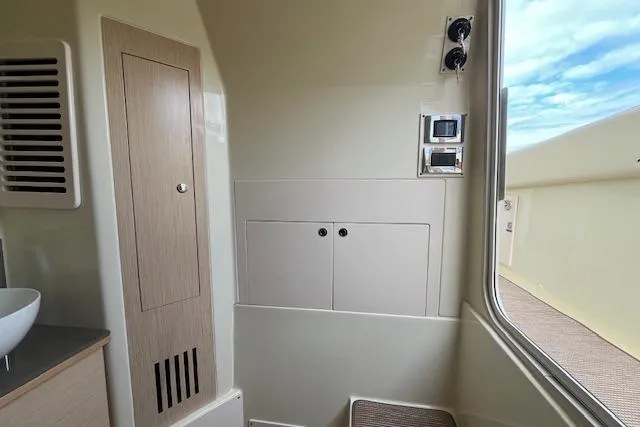 Slide: The Image of Interior of 2026 Chris-Craft Catalina 31, featuring modern cabinetry and control panel. - 18
