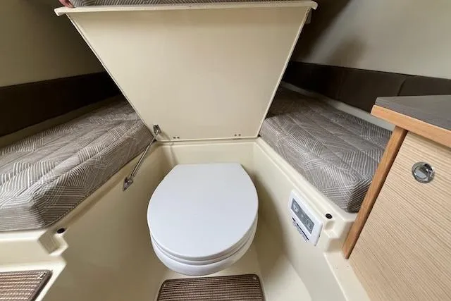 Slide: The Image of 2026 Chris-Craft Catalina 31 cabin interior with compact toilet and twin beds. - 21