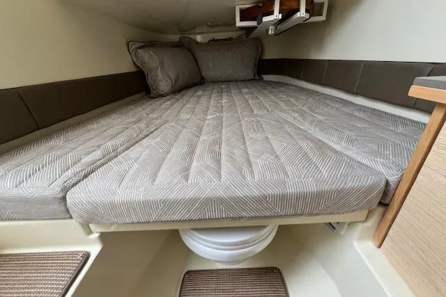 Slide: The Image of 2026 Chris-Craft Catalina 31 cabin interior with cozy bed and cushions. - 24