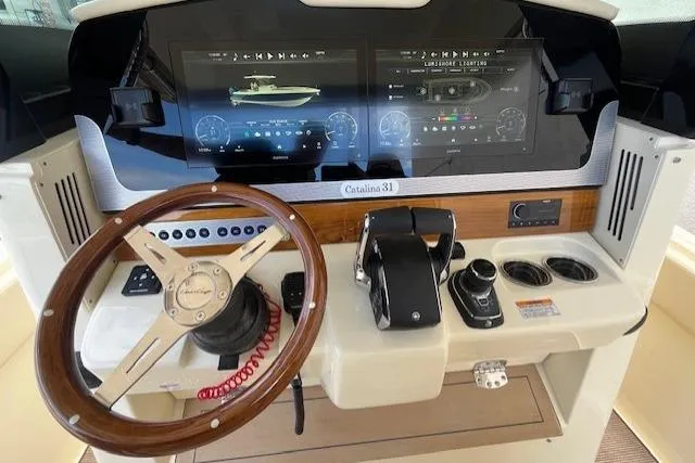Slide: The Image of 2026 Chris-Craft Catalina 31 dashboard with steering wheel, digital displays, and controls. - 3