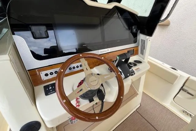 Slide: The Image of 2026 Chris-Craft Catalina 31 helm with wooden steering wheel and modern controls. - 4