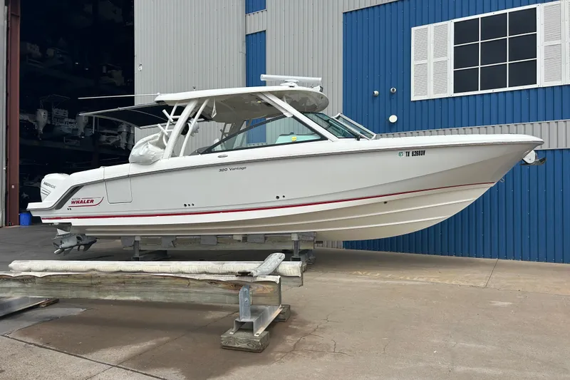 The Image of 2017 Boston Whaler 320 Vantage boat on a lift, dockside view. - 0