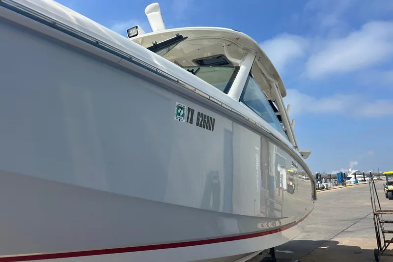 Slide: The Image of 2017 Boston Whaler 320 Vantage boat docked under clear blue sky. - 10