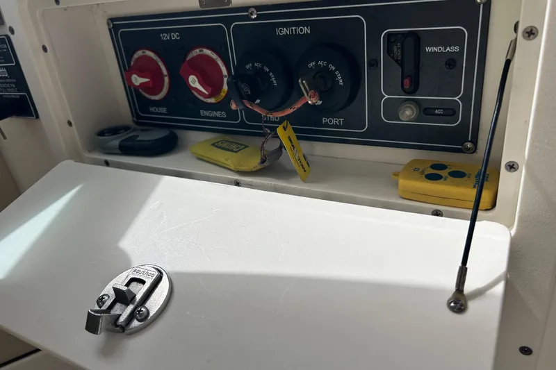 Slide: The Image of Control panel of a 2017 Boston Whaler 320 Vantage boat, featuring ignition and switches. - 13