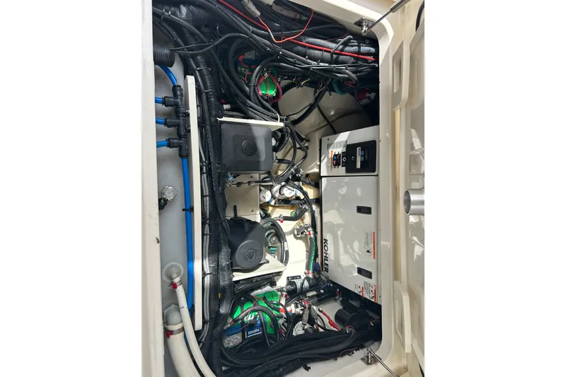 Slide: The Image of Engine compartment of a 2017 Boston Whaler 320 Vantage with Kohler generator and wiring. - 14