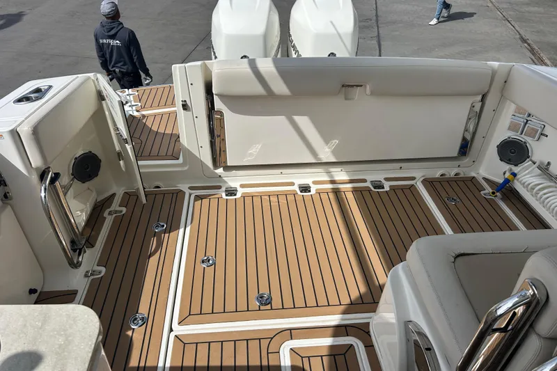 Slide: The Image of 2017 Boston Whaler 320 Vantage boat interior with teak flooring and seating area. - 17