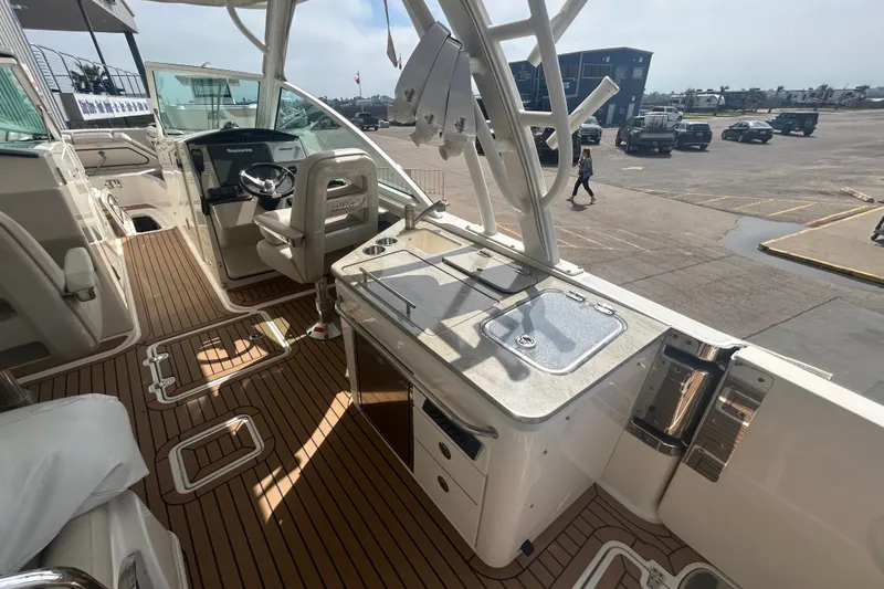 Slide: The Image of 2017 Boston Whaler 320 Vantage boat interior with helm and seating area. - 18