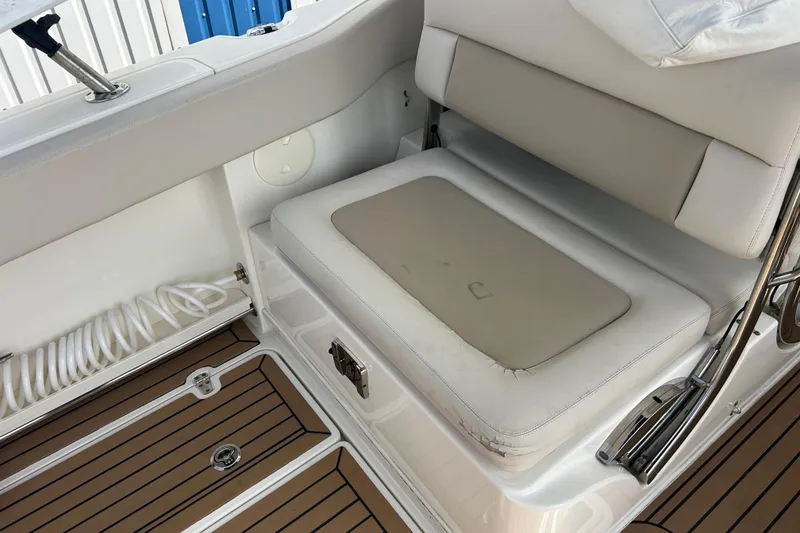 Slide: The Image of 2017 Boston Whaler 320 Vantage interior seating with cushioned bench and teak flooring. - 20