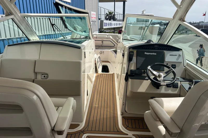 Slide: The Image of 2017 Boston Whaler 320 Vantage boat interior with Raymarine navigation system and seating. - 23