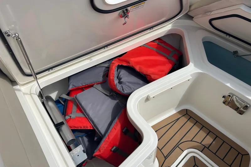 Slide: The Image of Storage compartment with life jackets on a 2017 Boston Whaler 320 Vantage boat. - 26
