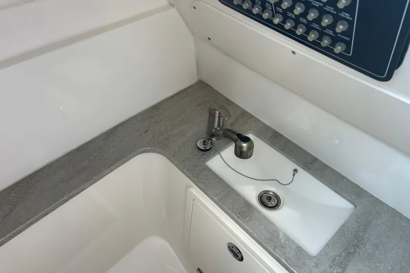 Slide: The Image of 2017 Boston Whaler 320 Vantage boat interior with sink and control panel. - 31