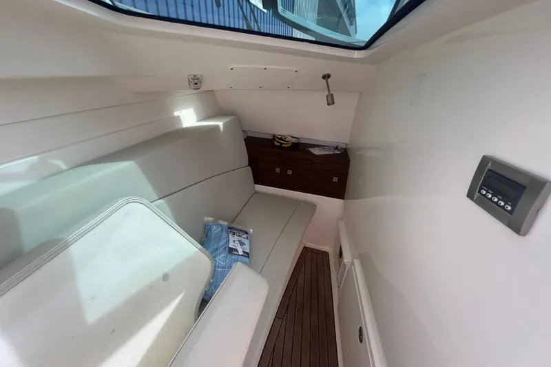 Slide: The Image of Interior cabin of 2017 Boston Whaler 320 Vantage with seating and control panel. - 33